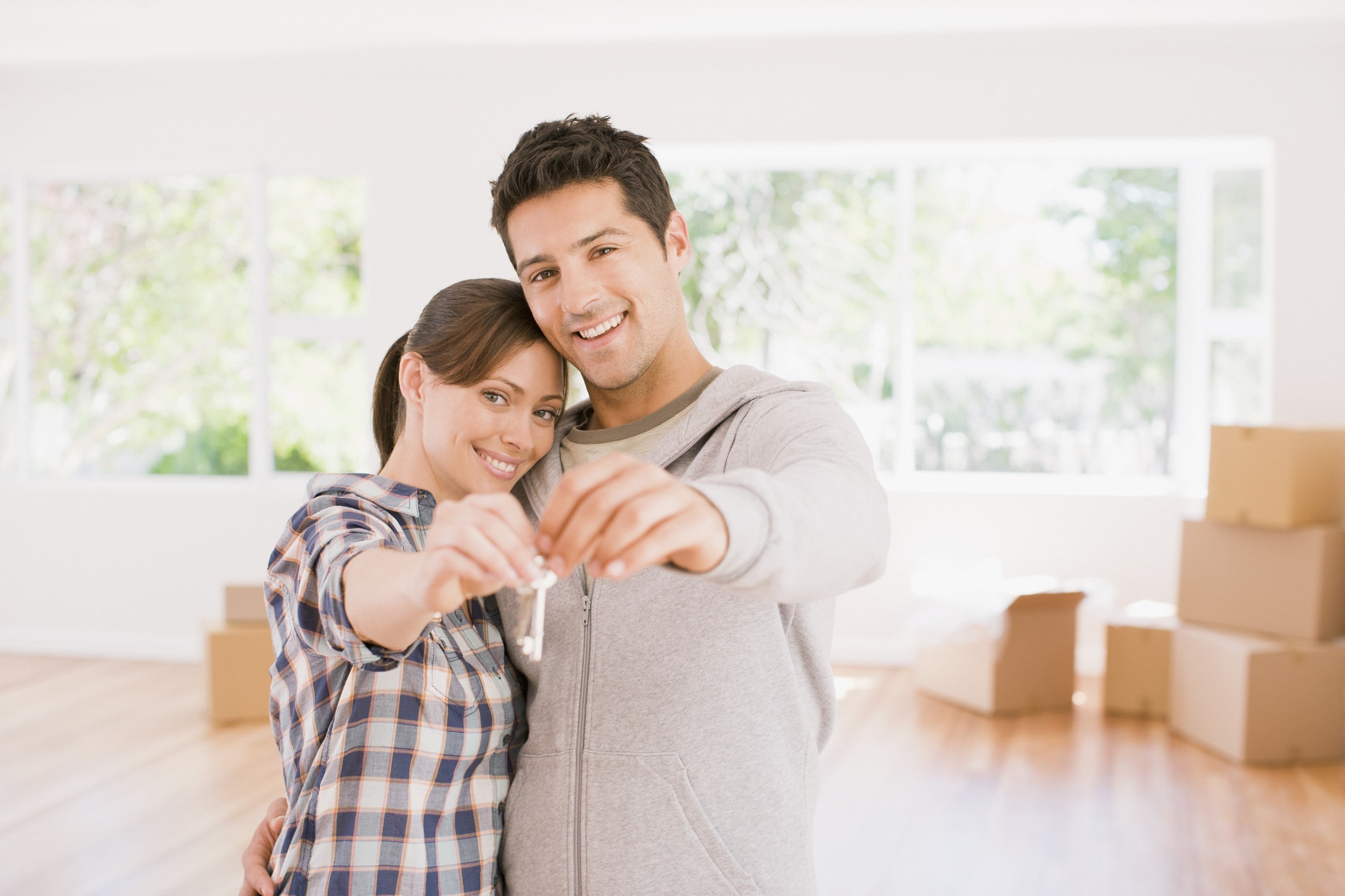 Couple holding the keys to their new house